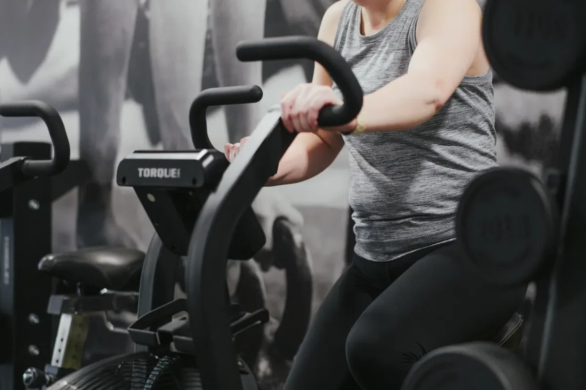 A member rides an air bike during a conditioning block at Alloy Personal Training Middleton in Middleton, WI.